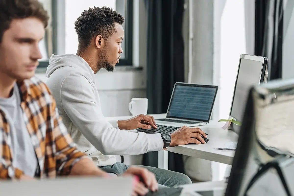 two coworkers concentrating on their computer tasks