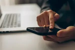 Person using a phone to make an appointment.