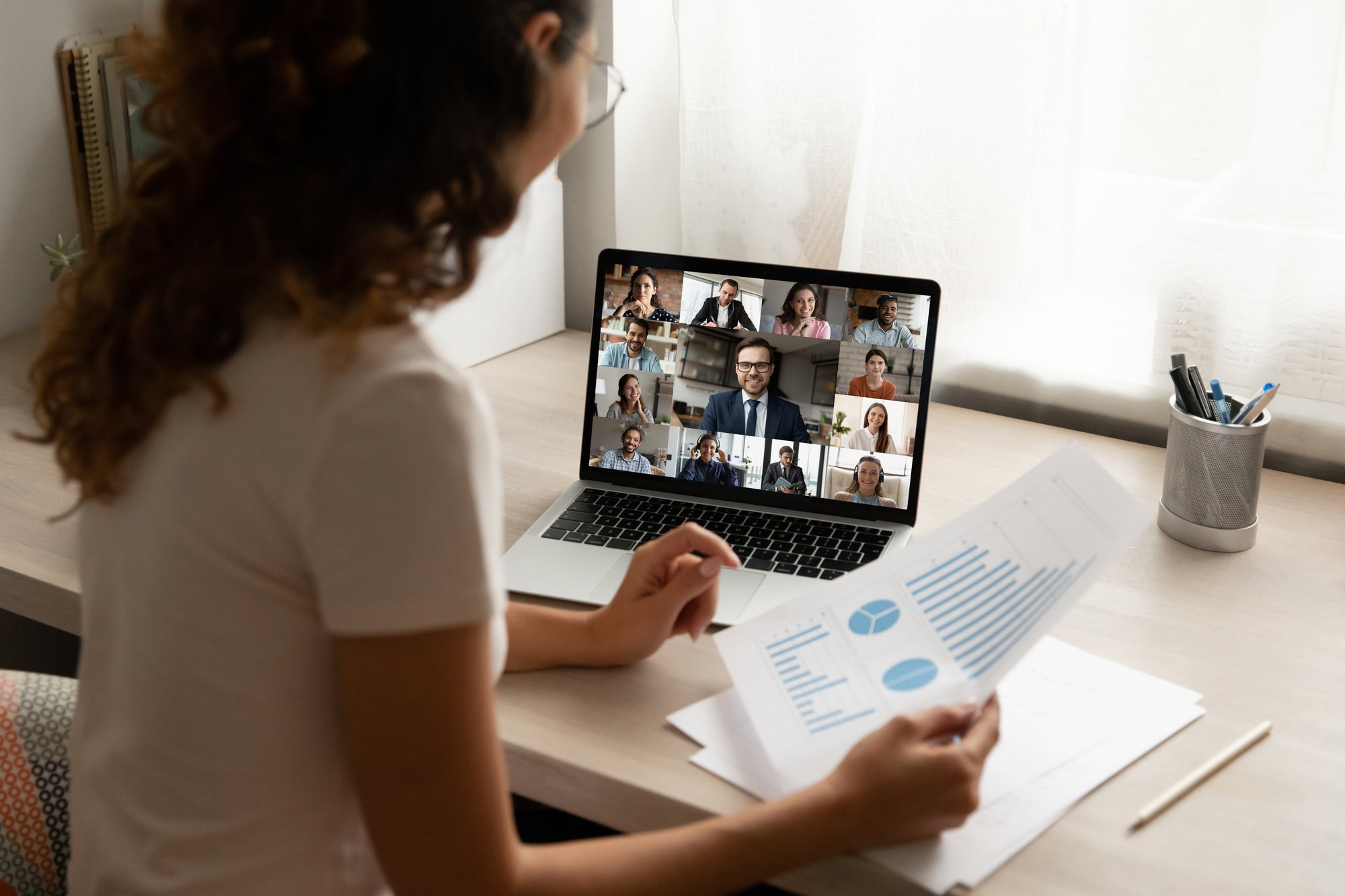 Woman looking a report during a virtual meeting