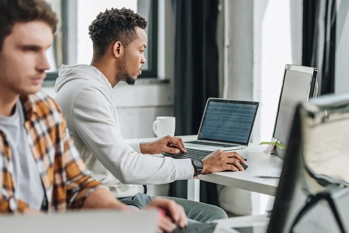 People working on their laptop and computer in an office