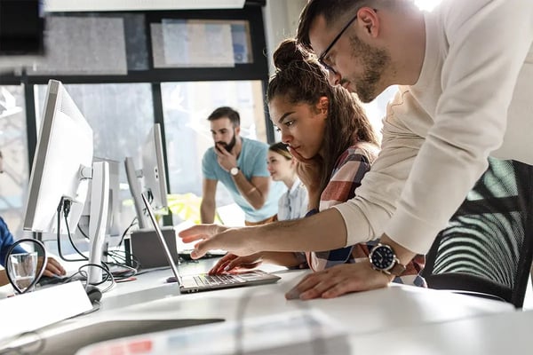 a diverse team of professionals diligently working on computers