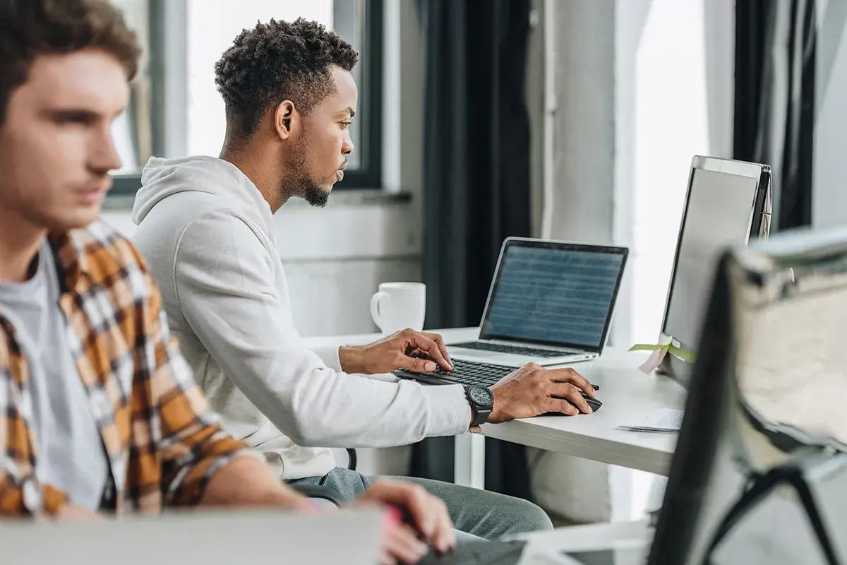 People working on their laptop and computer in an office